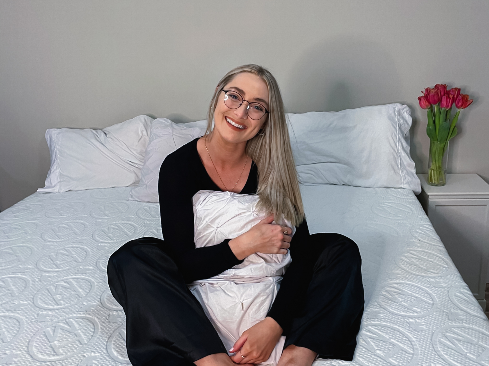 Woman with pillow on a bed, Haven Sleep Co Pillow