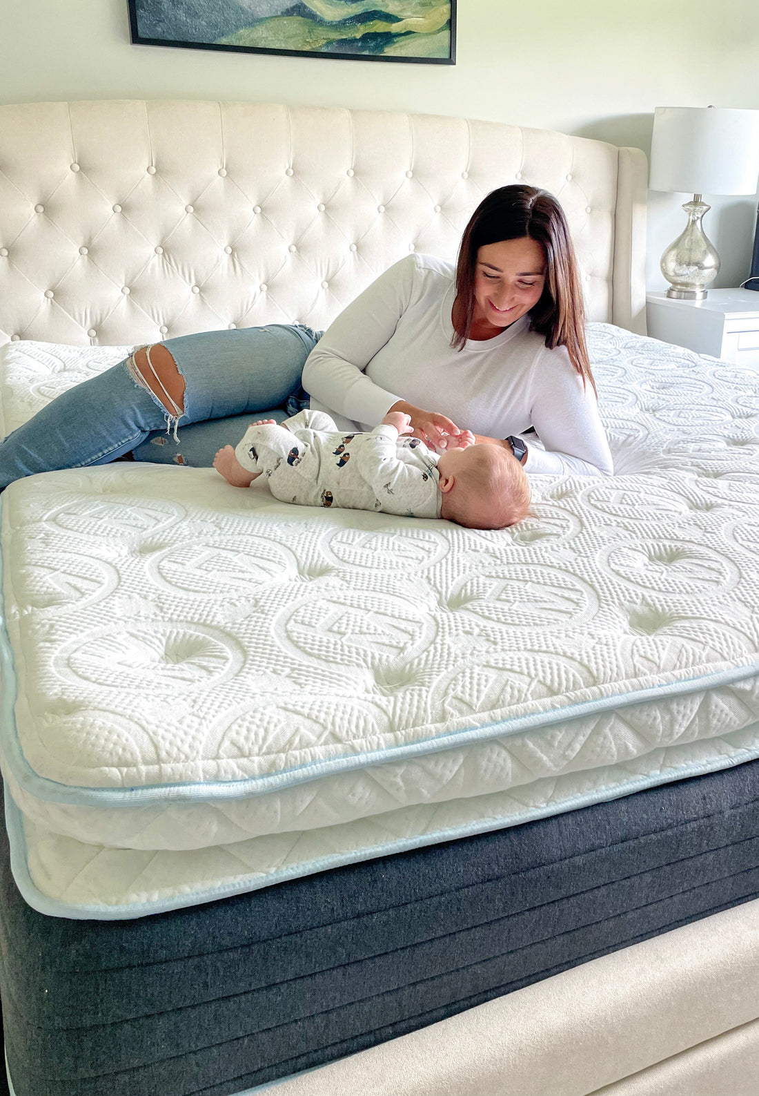 Mother and baby relaxing on a hypoallergenic Haven mattress with bamboo cover and latex comfort layers, promoting cool, chemical-free sleep.