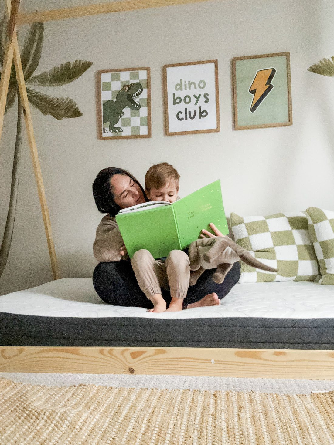 Mom and child sitting on bed reading
