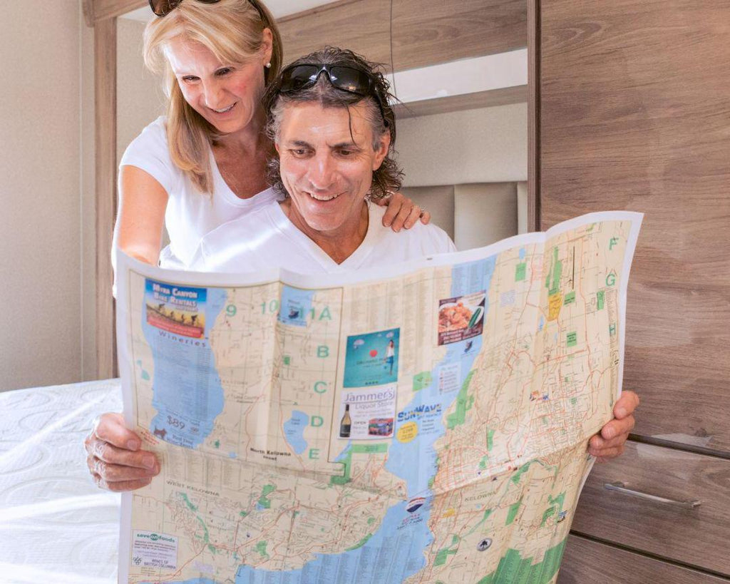 Husband and Wife looking at a map on their HIBER6 RV Mattress
