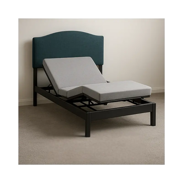 Adjustable bed with gray mattress and navy headboard in a room.