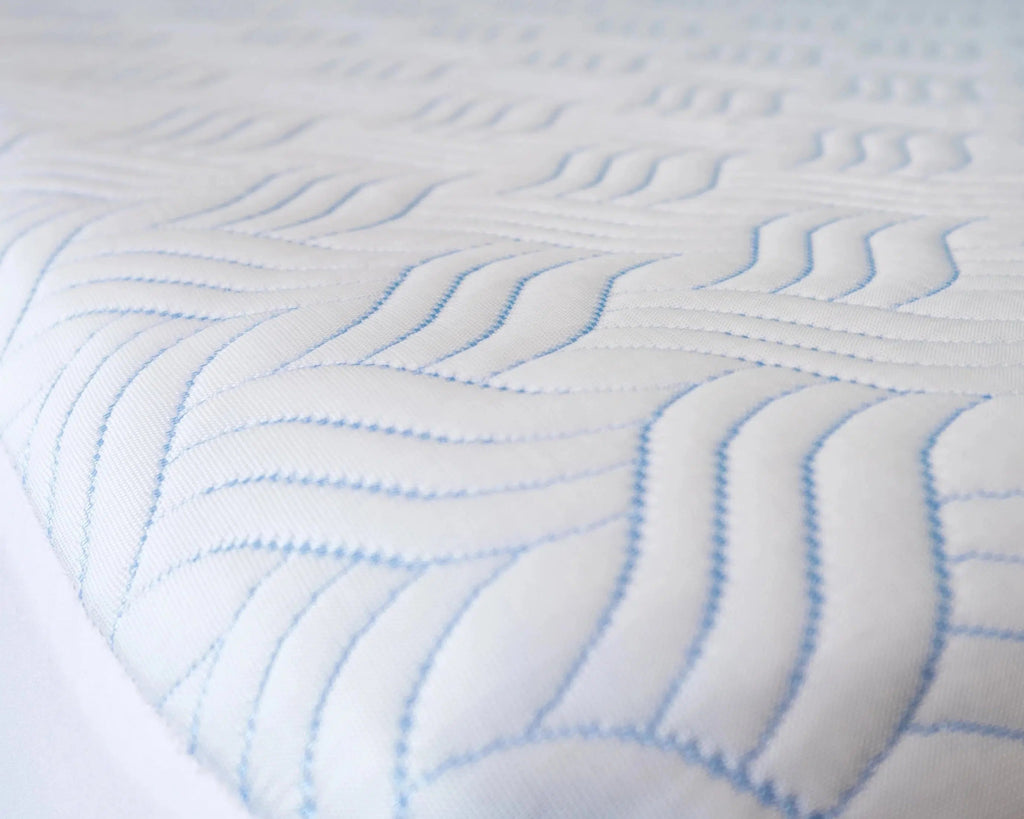 Side View of Haven Cool Ice Mattress Protector on Bed - Breathable, Waterproof Fabric with Wavy Stitching