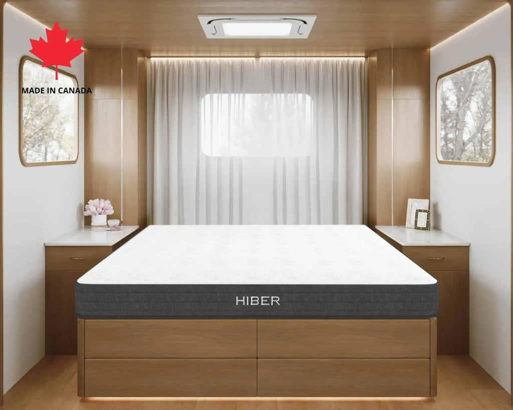 Hiber mattress in a modern bedroom setting with wooden furniture and a window.
