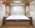 Hiber mattress in a modern bedroom setting with wooden furniture and a window.