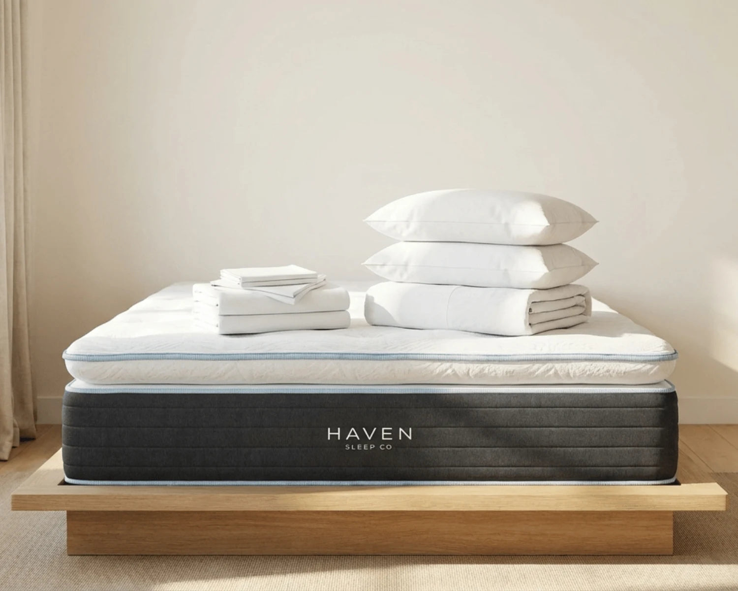 Mattress with Haven Sleep Co branding on a wooden platform against a neutral wall.