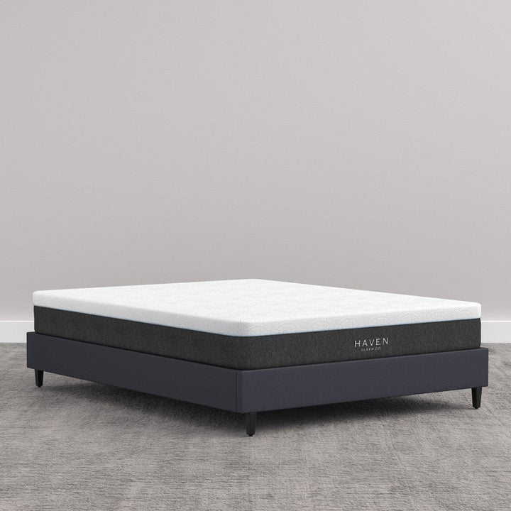 LUX Rejuvenate Mattress on bed frame showcasing sleek design and firm support.