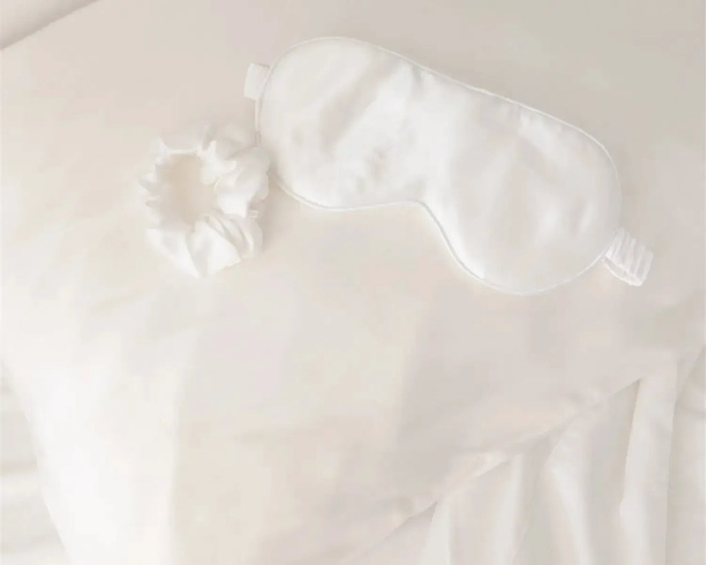 White satin eye mask on a white background