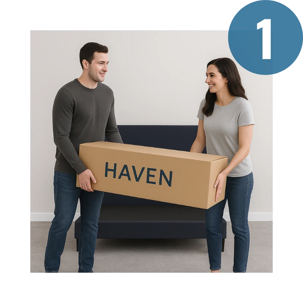 Two people holding a cardboard box labeled 'HAVEN' in a room.