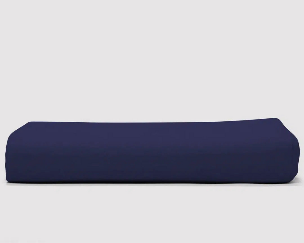 Lux Sateen Duvet Cover in Nighttime Navy, featuring a smooth and silky texture with a 500 thread count, folded neatly against a white background.