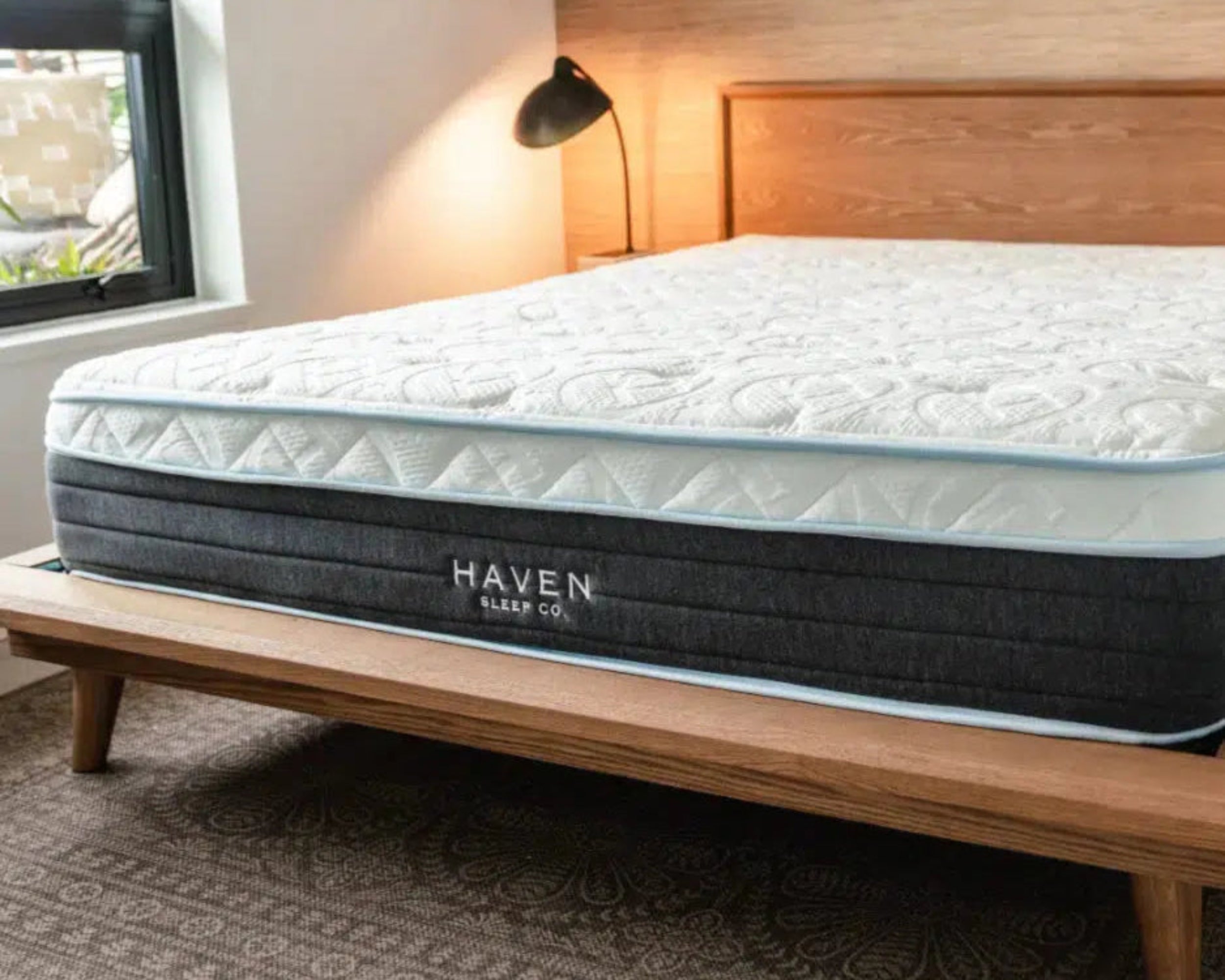 Haven Eurotop Hybrid mattress displayed on a modern wooden bed frame in a stylish bedroom, emphasizing comfort and support with clean, cool sleep technology