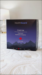 Haven Cool Ice Premium Mattress Protector in its box packaging with a mountain design and HealthGuard branding, featuring a red Canadian maple leaf symbol and size options listed on the front, displayed on a quilted mattress.