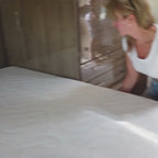 A woman placing her LUX Rejuvenate RV Mattress into her recreational vehicle (RV).