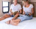 Husband and Wife reading on their HIBER 6 RV Mattress