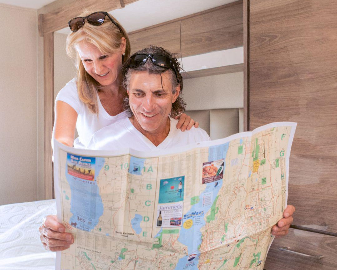Husband and Wife looking at a map on their HIBER6 RV Mattress