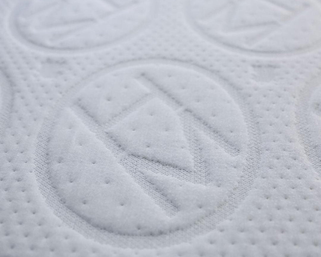 close up of haven jr 6" mattress with embossed logo. Bed materials are all plant based 