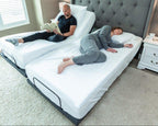 10 SPLIT KING_202105_split king_rejuvenate_adjustable_powerframe_bedframe_grey_middle age_ bri steve_side sleeper_side sleeper pillow_white sheets_white bedding_reading_working_book_ipad_couple-