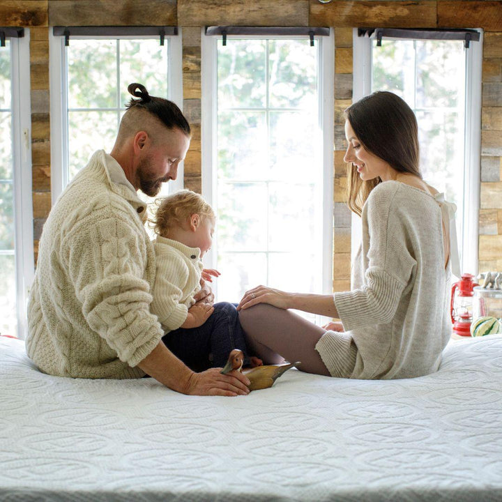 Mom, Dad and child playing on a HIBER6 Mattress
